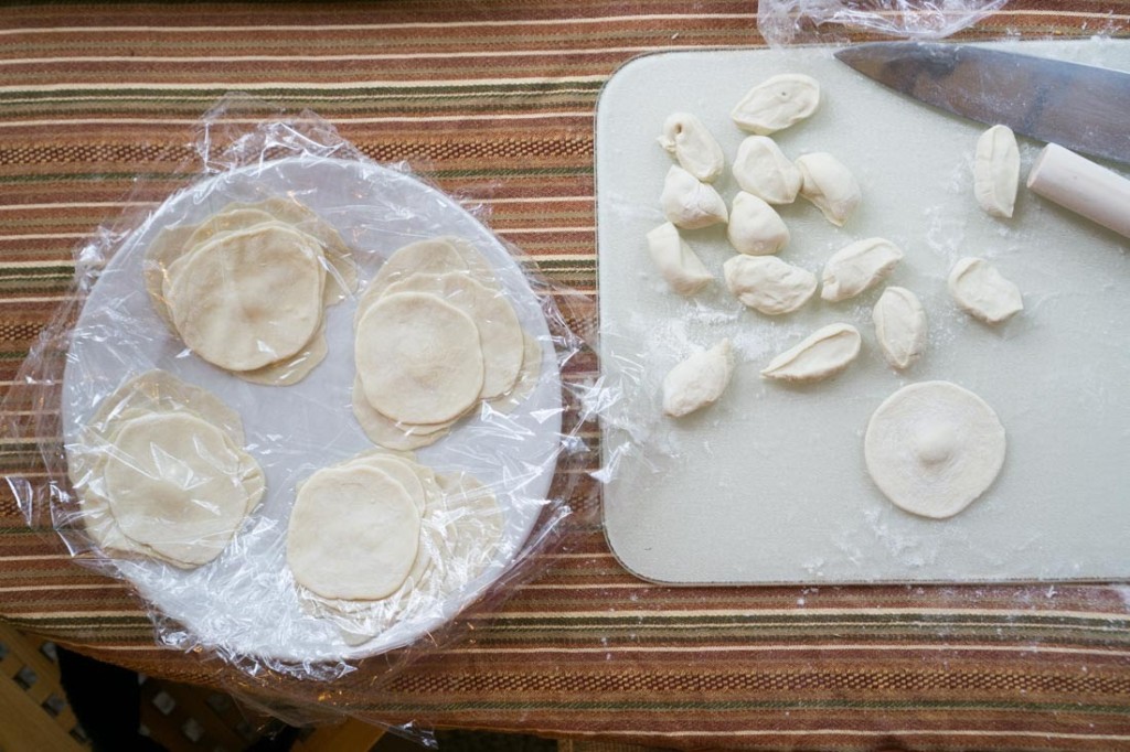 ...and eventually I was able to roll out decently round dumpling wrappers. Here, I've deliberately left the wrappers a little smaller in diameter than my desired final dumpling size, because I anticipate that the wrappers will stretch when I use them.