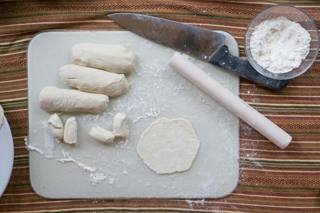 Roll each chunk of dough into a cylinder, and cut each cylinder into eight even pieces. Roll out each piece, trying to keep the edges even and the edges thinner than the middle.
