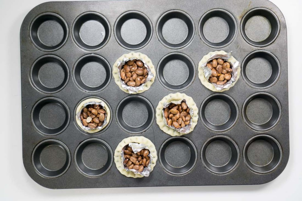 Yep, we're baking pinto beans here: blind-baking the tart shells